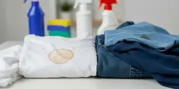 Assortment of stained fabrics with cleaning supplies, illustrating effective fabric stain removal.